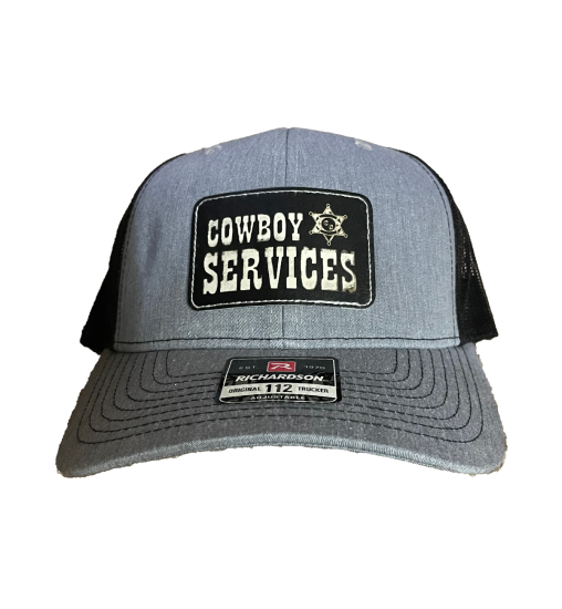 This is a Cowboy Services Cap. It is a black cap with the Cowboy Services logo on the front.